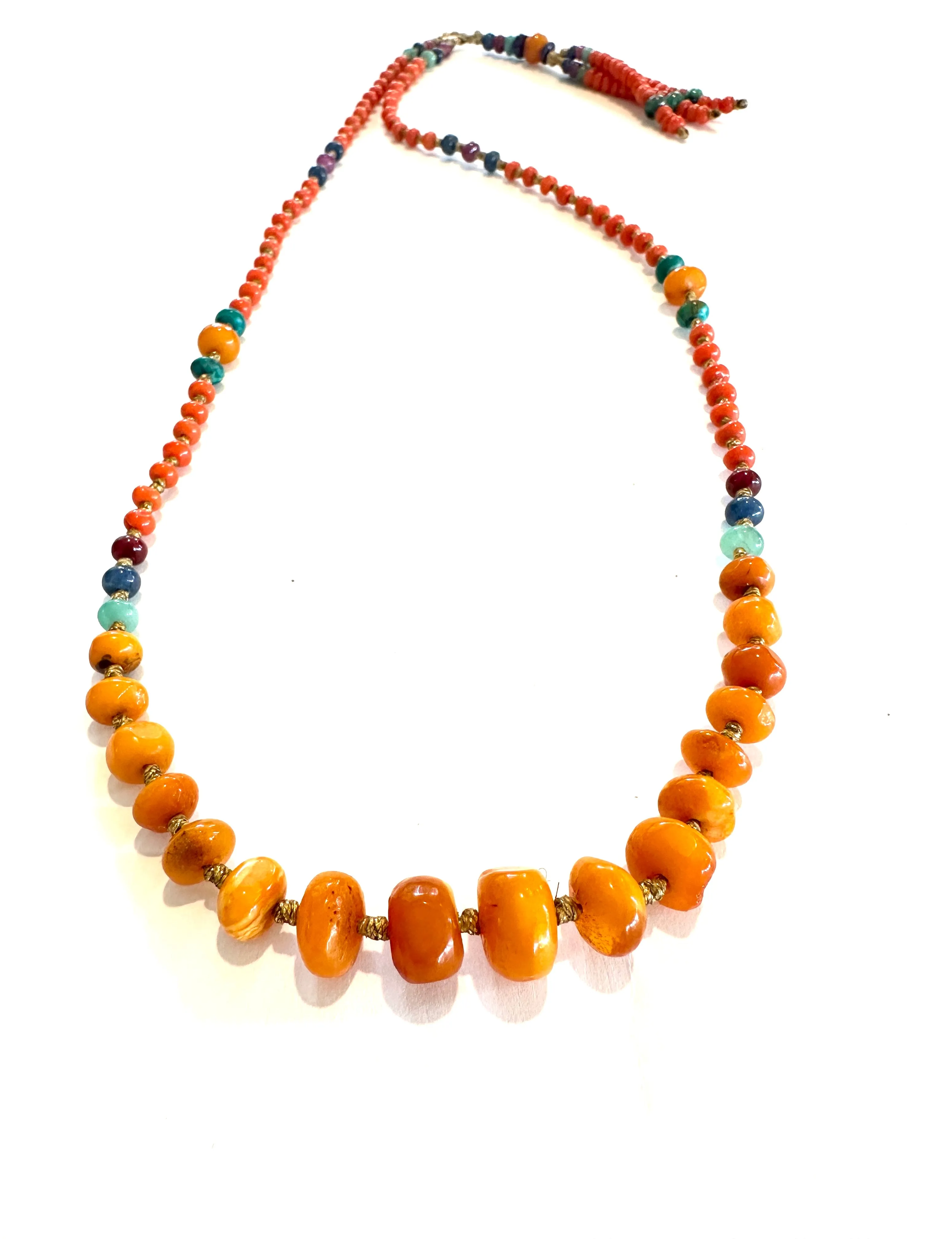 Antique amber stone with gold striomala necklace .